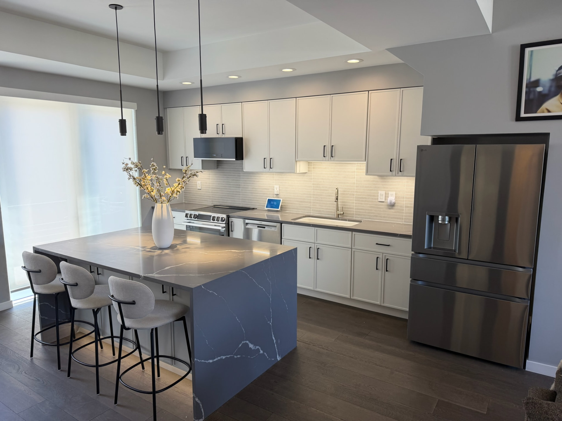 Remodeled kitchen looking toward sink and backsplash